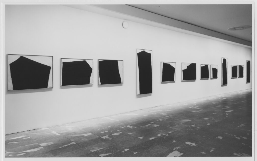 nine tv-sized prints are interspersed with tall portrait style prints hang on the white wall of moma in 1991, all of jagged black forms inspired by the basalt columns of richard serra's afangar sculpture in iceland. the floor is a mottled pale grey and white marble I wish I'd managed to salvage when they built the taniguchi project.