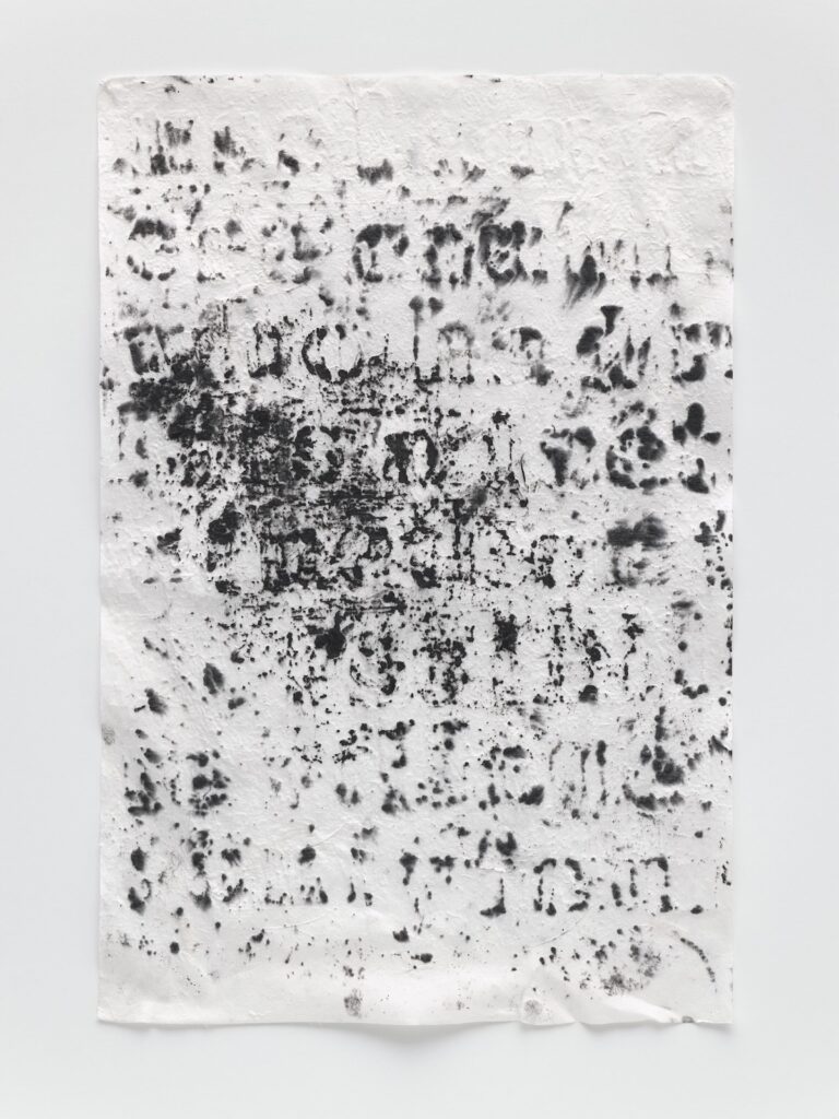 this carbon and graphite rubbing, which glenn ligon calls a kozo drawing because of the textured mulberry paper used for it, is vertically oriented, and shows the faint outlines of a stenciled text, almost enough to make you want to make out the words, not just the letters. a dark smudge obscures the left side of the three central rows. the size is 18 x 12 inches, it is untitled, but numbered (10), from 2023, and is on the fainter, more legible end of the series, it seems. it is not the one used for the fitzwilliam print tho