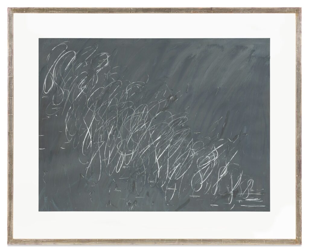 a framed cy twombly work on paper, 30 x 40 inches, is a medium grey background with noticeable brushstrokes, and a cascade of figure eights and fragments thereof in white crayon, descending from the upper left to the lower right, the same direction as duchamp's nude descending a staircase, of which this was once considered a study, which would make it kind of figurative, which might explain why it was de-titled when it sold at sotheby's in nov 2024