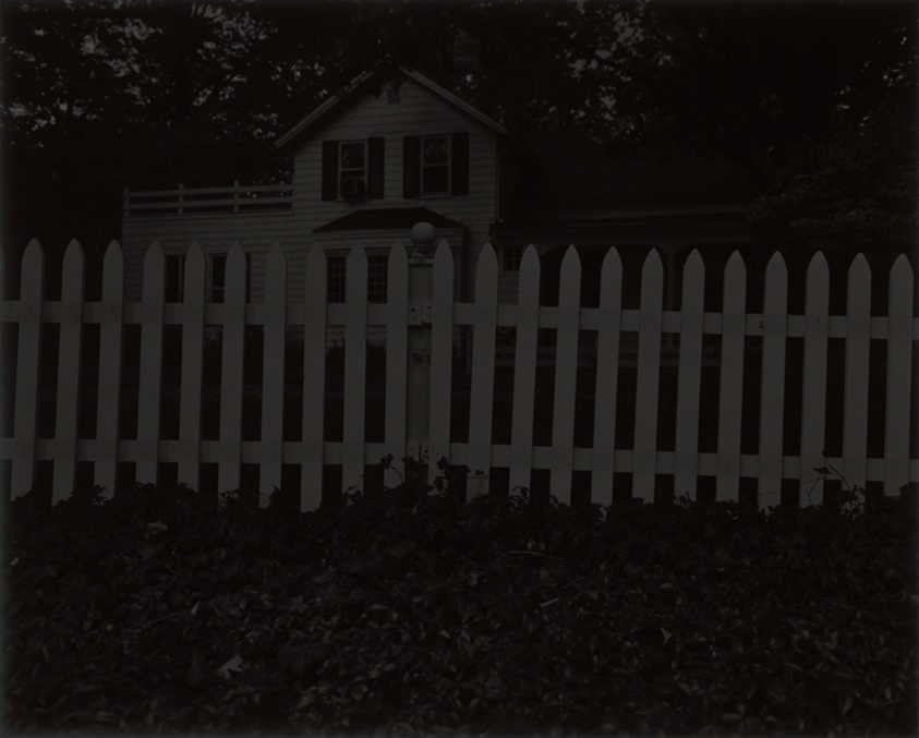 dawoud bey black and white print of a photo of a 19th century farmhouse and white picket fence outside cleveland, a speculated stop on the underground railroad, this image is darker to better approximate the extremely dark print bey made, which the art institute of chicago aquired