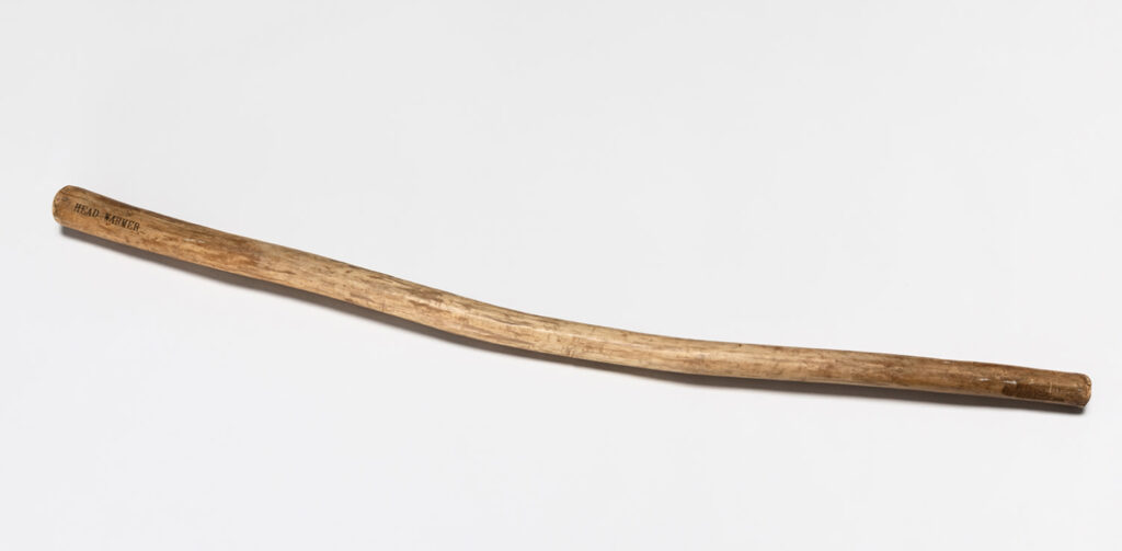 this sculpture by david hammons is a one meter long stick that has been smoothed a bit, and has the words head warmer on one end. it is being sold for the second time by marianne hoet, whose father jan obtained it from hammons. this image is from phillips, where marianne works, and where it did not sell in 2023. now in december 2024 it is at christie's, which has to sting a bit. maybe if they added some duct tape