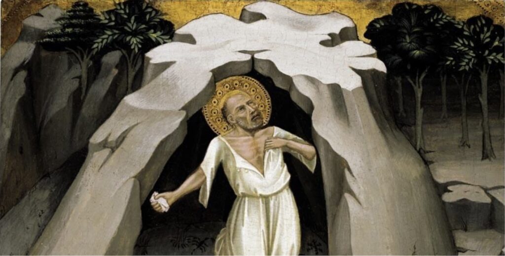 a c. 1400 panel painting of saint jerome in a white tunic standing in the mouth of a dome-like cave of grey smooth stone, with an outcropping of rocks on one side, and a few trees on the other, all against a background of gold leaf, by lorenzo monaco