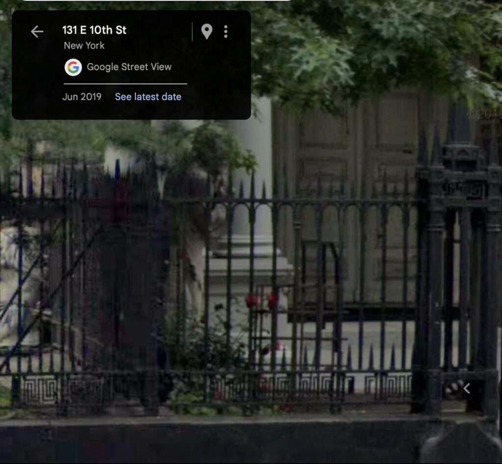 a detail from a google streetview screencapture from june 2019, where roses bloom amidst or around gordon matta clark's rosebush grid cage, behind the church's much more elaborate wrought iron fence. the columns and porch of the church are in the background.