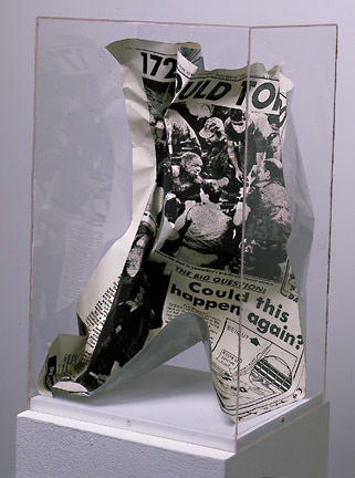 a page from a 1983 new york post screenprinted onto aluminum sheet, and crumpled up a bit, in a plexi vitrine, via ronald feldman gallery