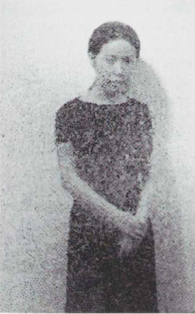 kusama is a young japanese woman in a black short sleeved dress, hair pulled back, arms crossed in front of her, and a dour expression on her face. she stands in front of an infinity net painting, and there is a double exposure which covers her and the entire image with an infinity net pattern of painted white loops. c. 1960, via moma's 1998 catalogue, i think