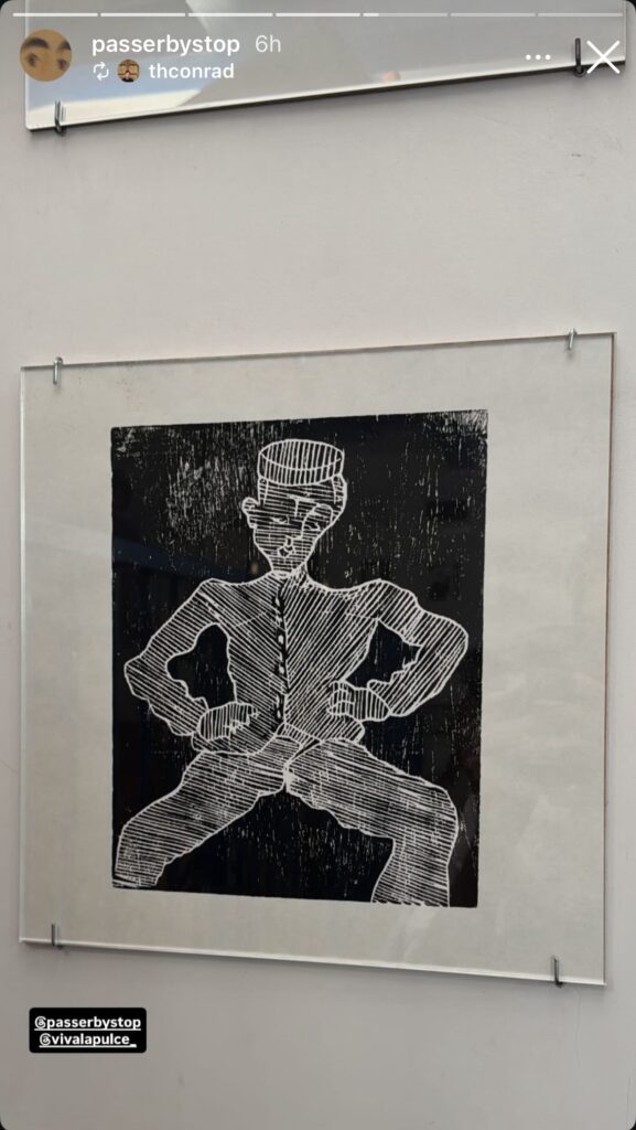 a screenshot of passerbystop's post of a photo of a square-ish black on white woodblock print of soutine's bellboy, made of thin hatching marks, pinned under a sheet of glass, at la pulce in roma in june 2025
