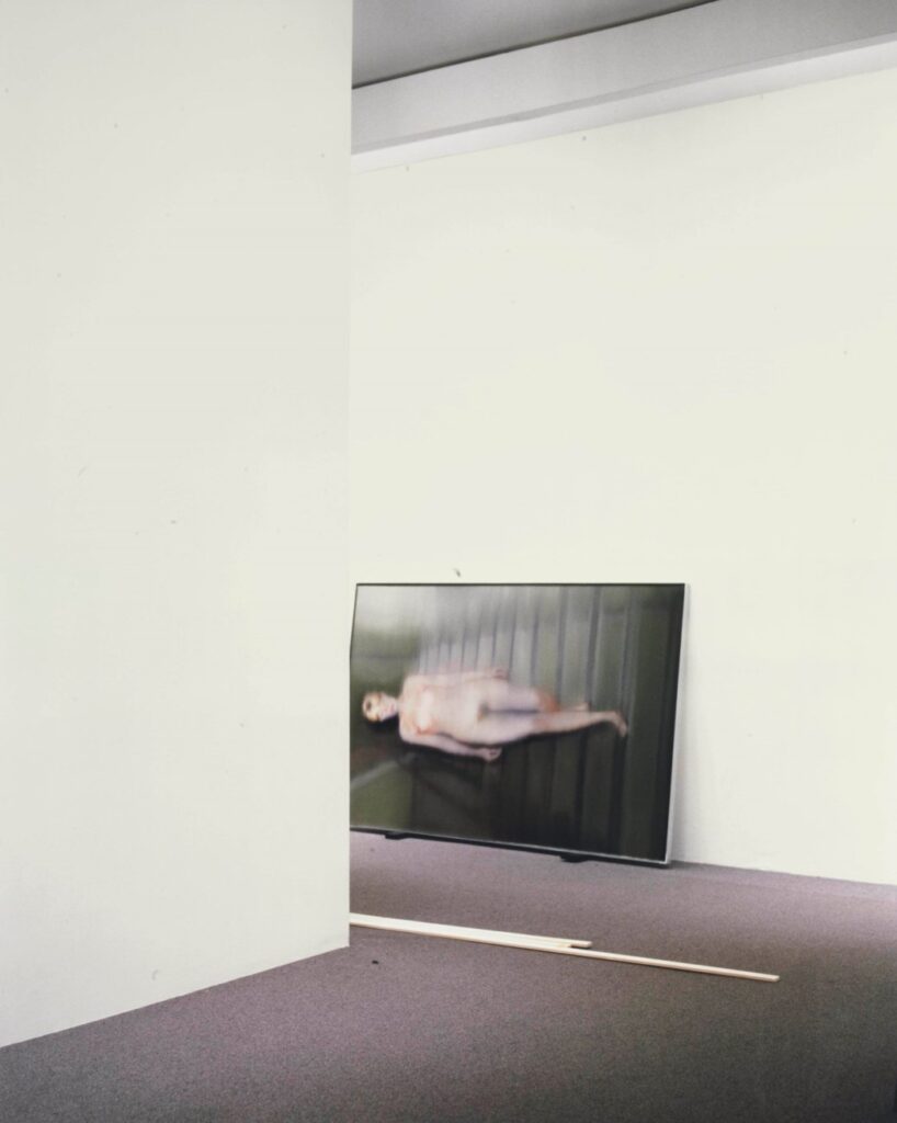 2003 louise lawler photo of a gerhard richter photo of a blurred painting of his wife descending a staircase, turned on its side as it waits for installation or shipment in a christies showroom, sold at christies in 2012