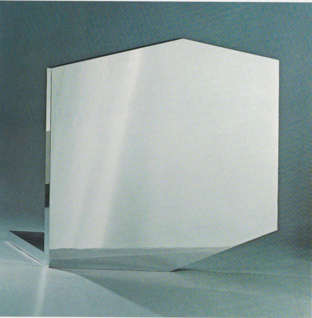 a circa 1971 saturated color photo of ellsworth kelly's truncated square/hexagonal sculpture, mirrored concorde, is a sheet of chrome plated stainless still with a matching flat base/brace attached behind it. the photo shows light refracting off the ediges, and reflected shadows and such in the surface, via gemini gel and moma