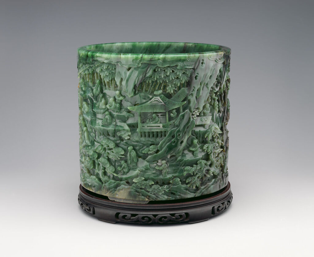 a cylindrical jade brush holder in deep green, carved all over with an intricate and sometimes perforated high relief scene of some ancient relevance involving a pavilion and poets, a sign of the qianlong emperor's erudition, which was looted by the british and french in 1860, trafficked to an american in shanghai, sold at tiffany's to a nyc robber baron, who left it to the metropolitan museum, where he was a trustee.